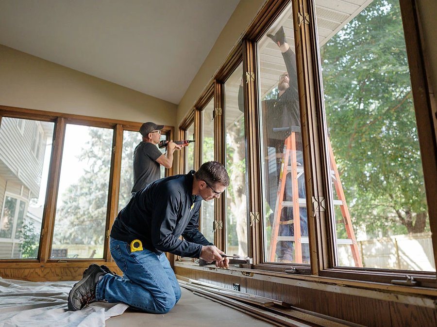 Installer fitting a new energy-efficient replacement window